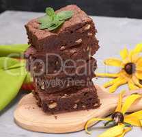 stack of square pieces of chocolate brownie cake with walnuts