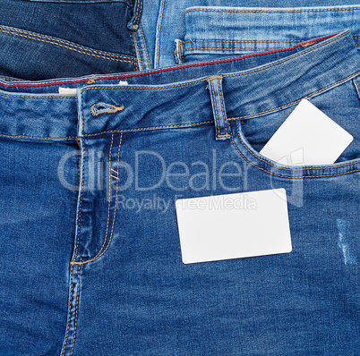 empty paper card lies on blue jeans