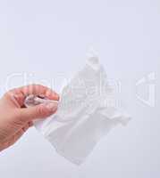 female hand holding a clean white paper napkin for face