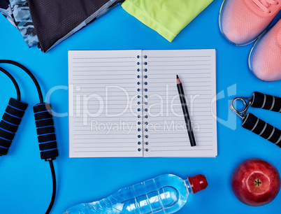 open empty notebook and  women's clothing for sports and fitness