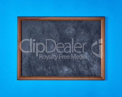 wooden empty chalk board on a blue background