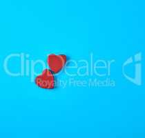 two red wooden hearts on a blue background