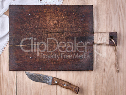 old wooden kitchen cutting board and knife