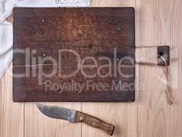 old wooden kitchen cutting board and knife