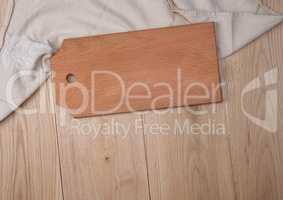 wooden rectangular cutting board and kitchen towel