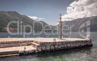 Pier on the island near the old church in Montenegro