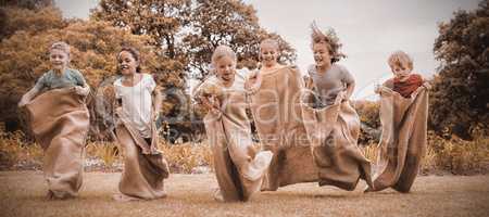 Children having a sack race in park