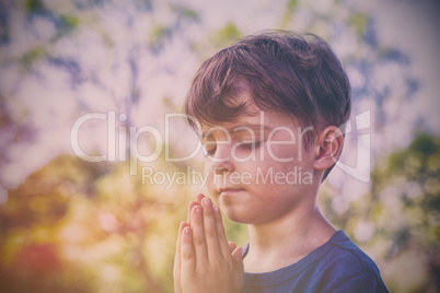 Boy praying with eyes closed