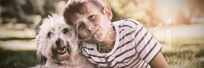 Portrait of boy with dog in park