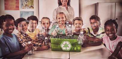 Portrait of pupils and teacher recycling