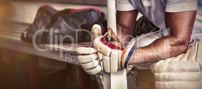 Stressed cricket player sitting on bench