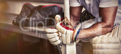 Stressed cricket player sitting on bench Stressed cricket player sitting on bench
