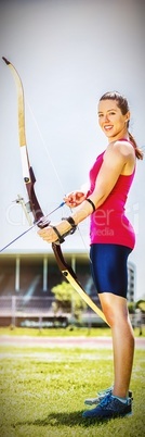 Female athlete practicing archery