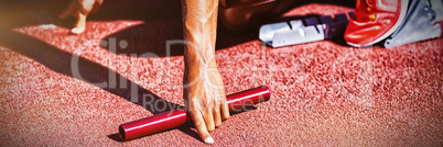 Female athlete ready to start relay race