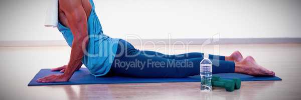 Man doing cobra pose on exercise mat