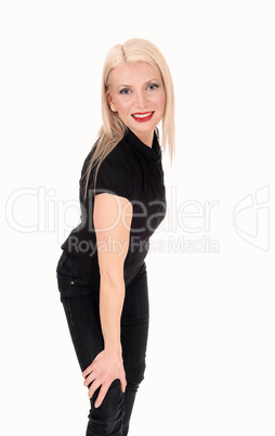 A happy looking blond woman standing in black outfit