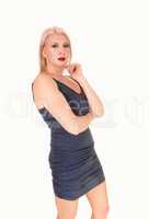 Beautiful woman standing in a short blue dress
