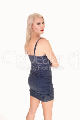 Lovely woman standing from back in dress