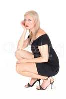 Gorgeous blond woman crouching on floor