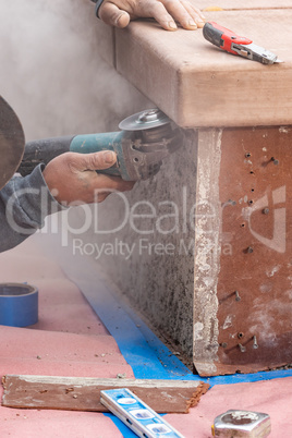 Construction Worker Using Grinder At Construction Site