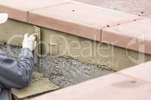 Tile Worker Applying Cement with Trowel at Pool Construction Sit