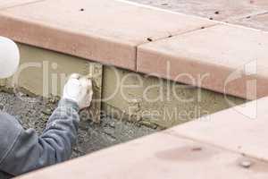 Tile Worker Applying Cement with Trowel at Pool Construction Site