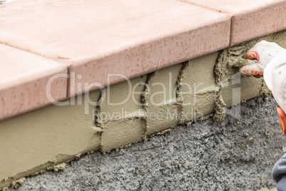 Tile Worker Applying Cement with Trowel at Pool Construction Sit