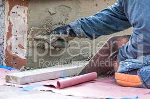 Tile Worker Applying Cement with Trowel at Pool Construction Sit