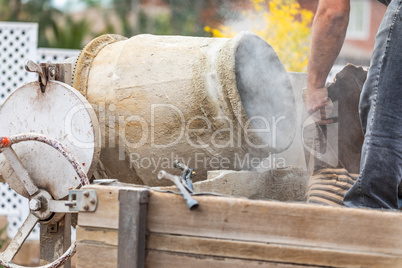 Construciton Worker Mixing Cement At Construction Site
