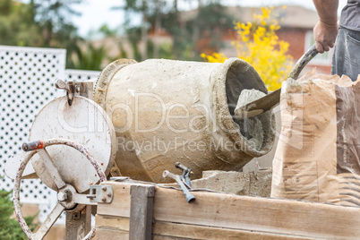 Construction Worker Mixing Cement At Construction Site