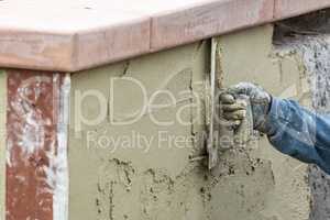 Tile Worker Applying Cement with Trowel at Pool Construction Sit