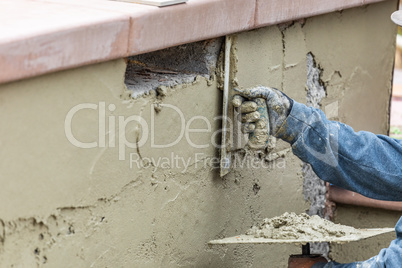 Tile Worker Applying Cement with Trowel at Pool Construction Sit