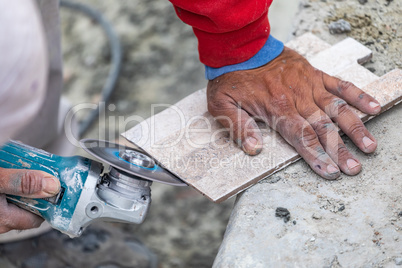 Worker Grinding Corner Tile for Fitting