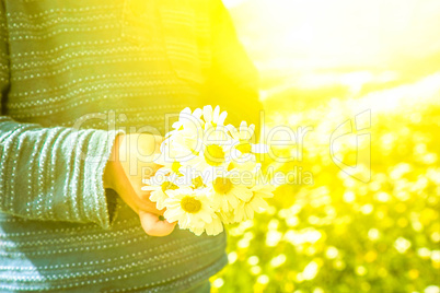 Little Child Is Holding A Bouquet Of Daisy Flower