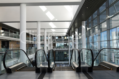 Front view of escalators in first floor of a big workplace