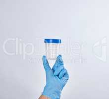 hand in a blue sterile glove holds a plastic container for colle