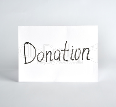 inscription donation  black marker on a white sheet of paper