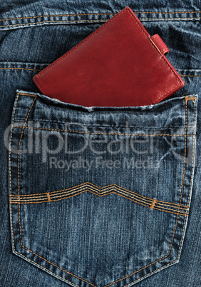 Brown leather wallet in the back pocket of blue jeans