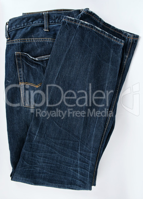 folded blue men's jeans on a white background