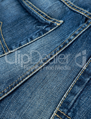 fragment of blue jeans with stitching