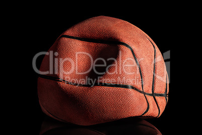 Deflated and rumpled old basketball ball
