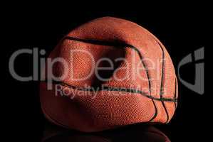 Deflated and rumpled old basketball ball