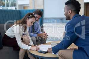 Caucasian businesswoman signing the contract papers in the lobby