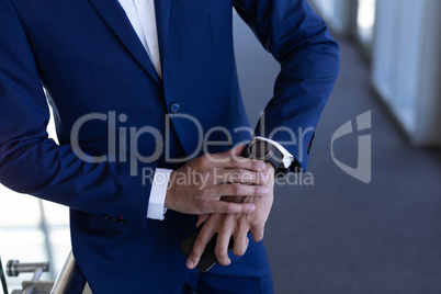 Elegant businessman using smartwatch in modern office Elegant businessman using smartwatch in modern office