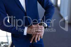 Elegant businessman using smartwatch in modern office