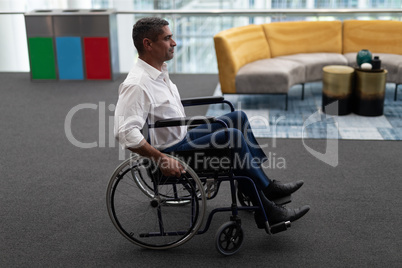 Caucasian disabled businessman sitting on wheelchair in office