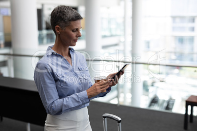 Caucasian businesswoman using mobile phone in office