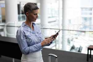 Caucasian businesswoman using mobile phone in office