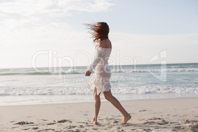 Young Caucasian woman walking on the beach