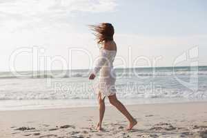 Young Caucasian woman walking on the beach